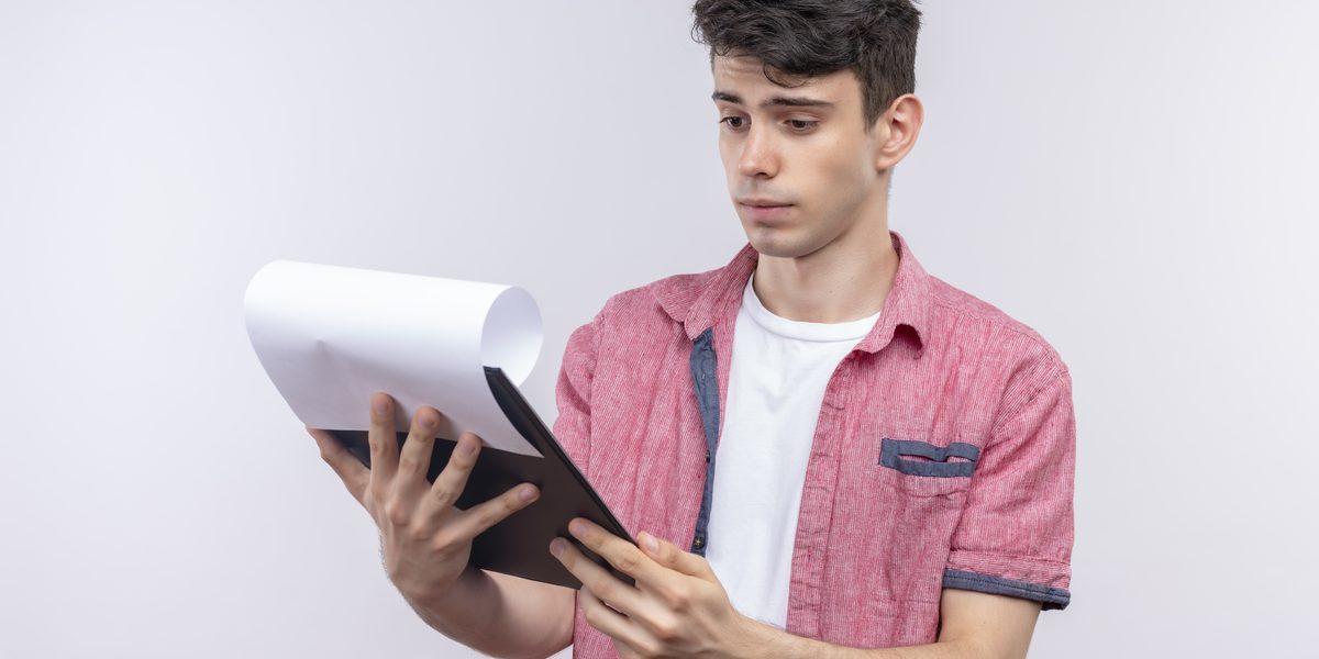 Man reading the pages of a bill on a clipboard